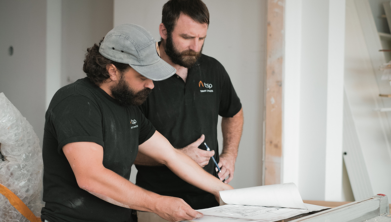 two integrators looking down at blueprint